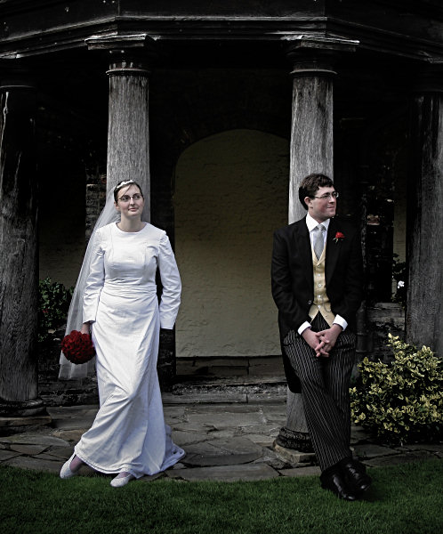 Wedding bride and groom in front of wooden pillars