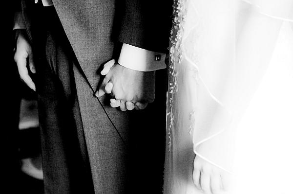 Bride and Groom hold hands during wedding ceremony