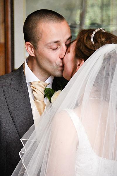 Bride and Groom kiss at end of wedding ceremony